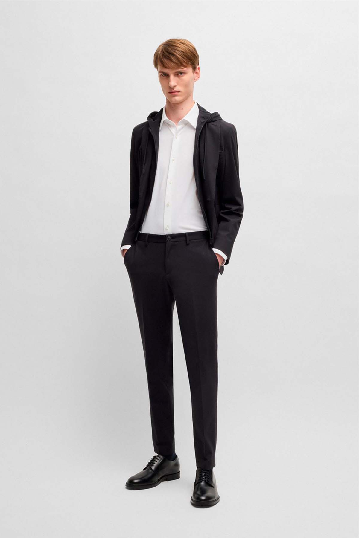 Pantalones slim fit de punto elástico técnico image number 3